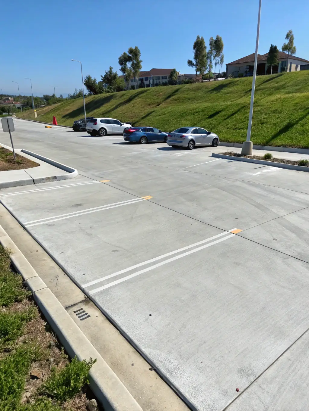 A large commercial parking lot with clean lines and organic textures, demonstrating durability and modern design, used to represent Panos Concrete's commercial concrete construction services.